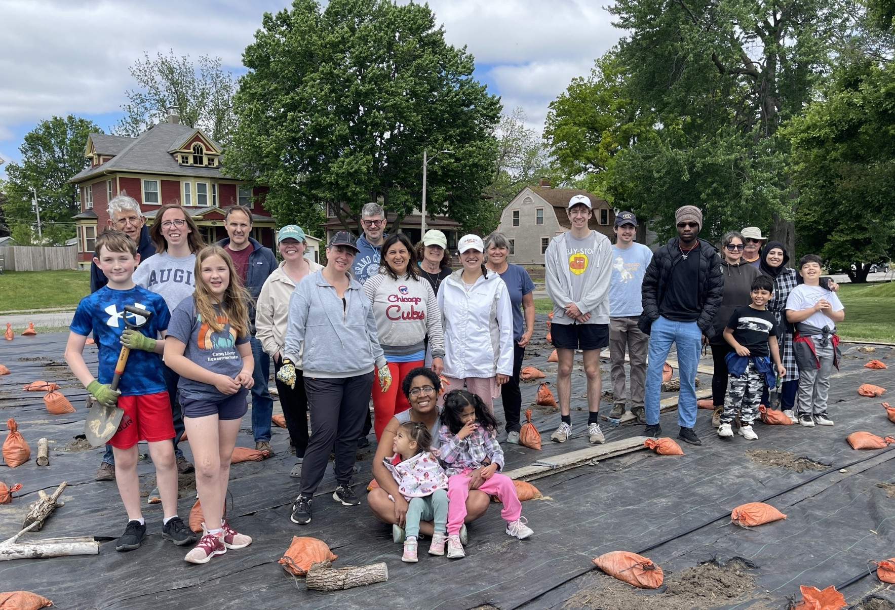 a large group of Tapestry Farms volunteers at an urban farm